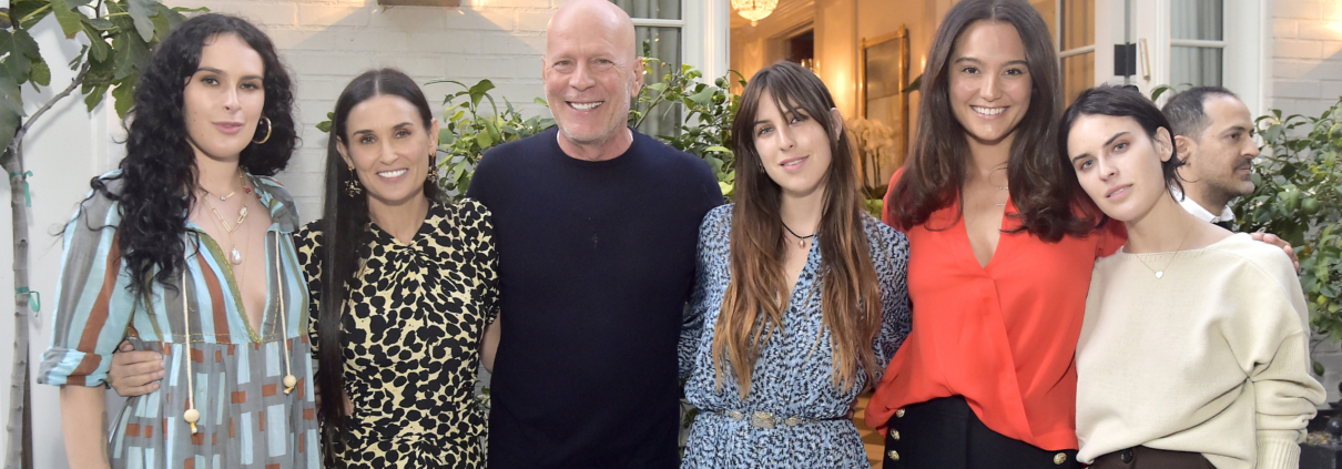 Actor Bruce Willis smiles for the camera with his family, including former wife Demi Moore.