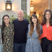 Actor Bruce Willis smiles for the camera with his family, including former wife Demi Moore.