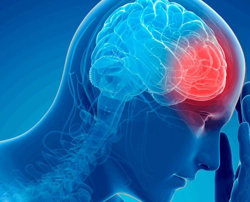 An illustration of a human head is shown in profile. Like an X-ray, we can see the spinal column and brain. Everything is in blue colors except for an area at the front of the brain that is in red. And the human his holding their hand to their head.