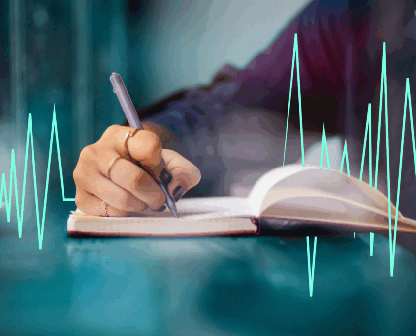 A white hand writes in a journal and a green heart rhythm image goes across the page.