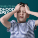 A young white boy around age 8 has his eyes closed and hands on the front of his head as if in pain or frustration. The image has the words "Developments in Childhood Epilepsy" on it.