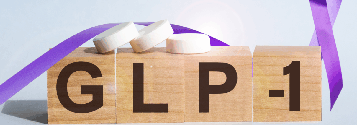 Four small brown blocks, similar to Scrabble tiles sit next to each other and spell out GLP-1. Three small white pills sit on top of the blocks and an image of a purple ribbons winds its way around the blocks.